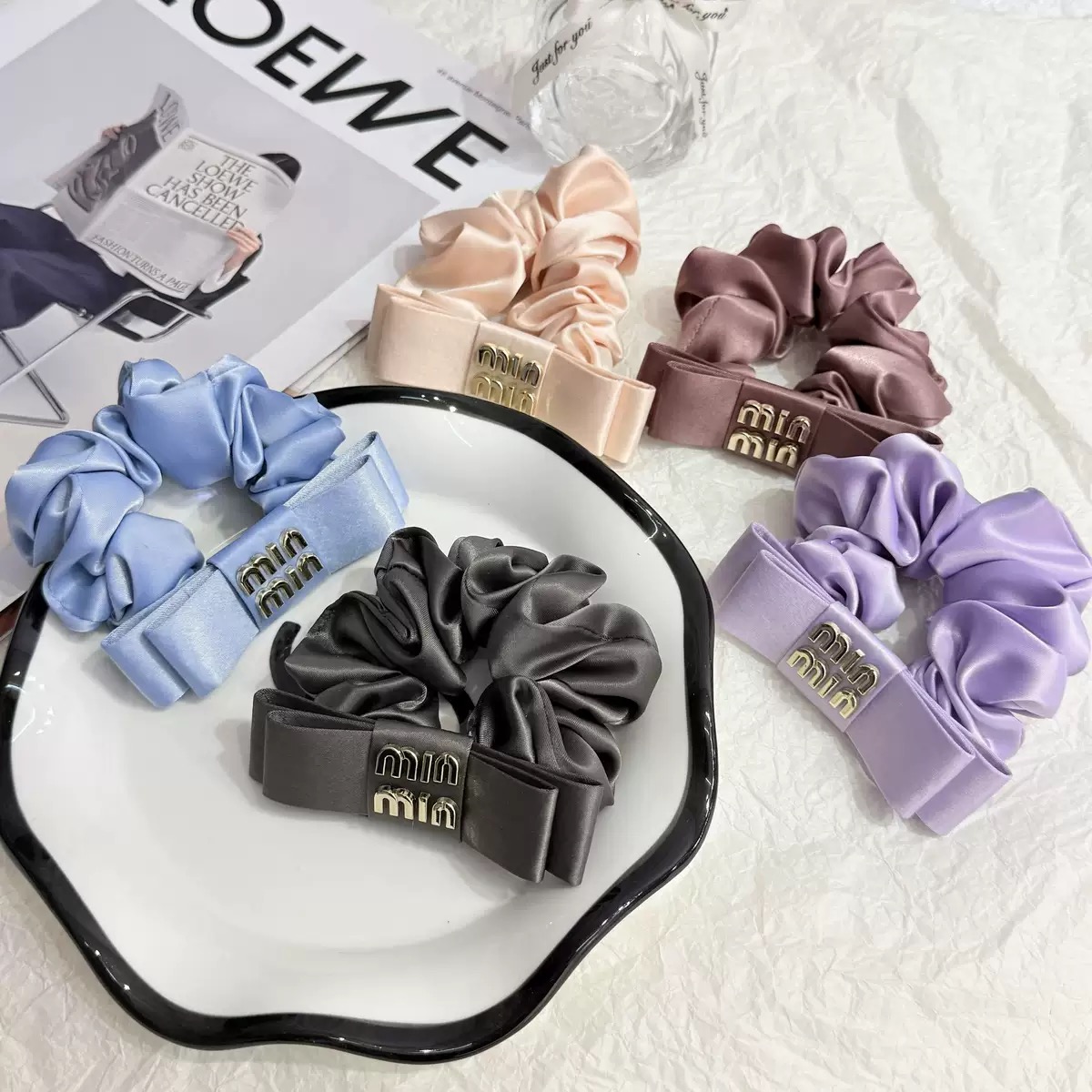 Fabric-wrapped hair ties with embellishment