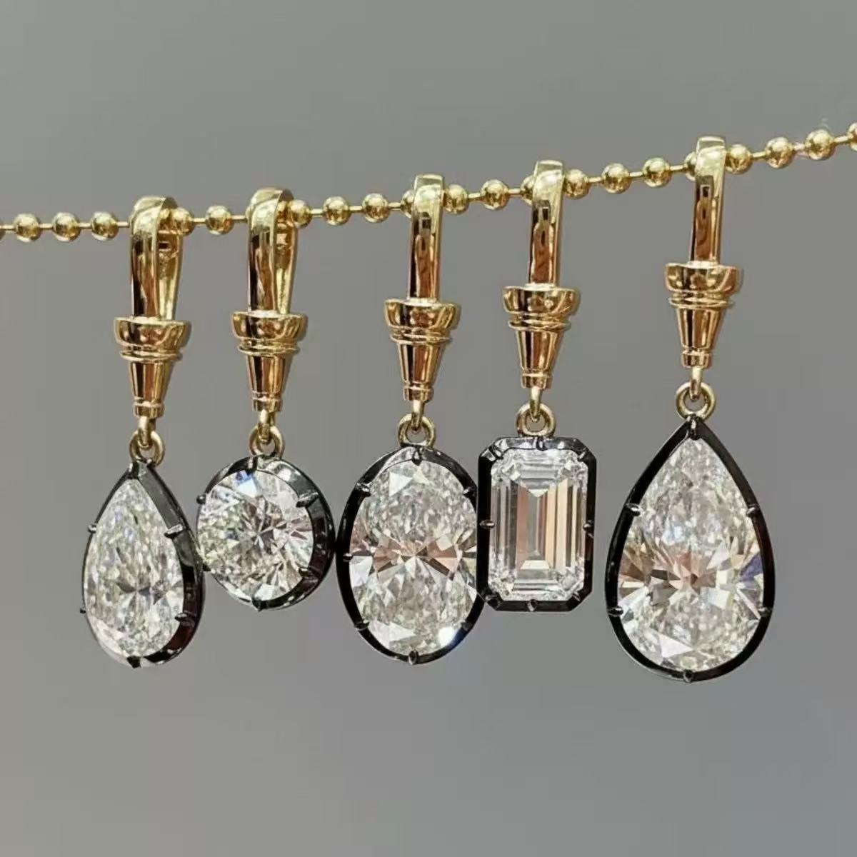 Clear faceted pendant references in several silhouettes with visible attachment fittings
